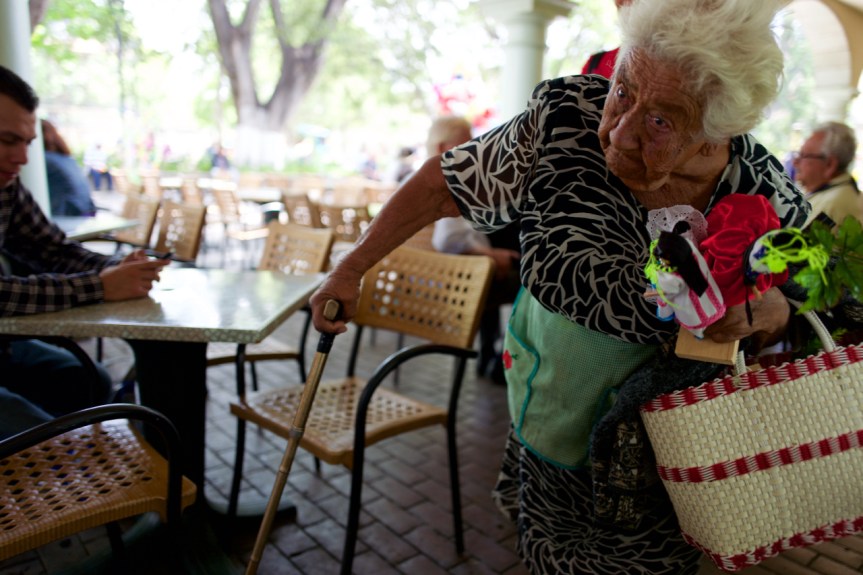 Daily struggle... This is a tough shot for me. This poor old lady's plight of daily survival...