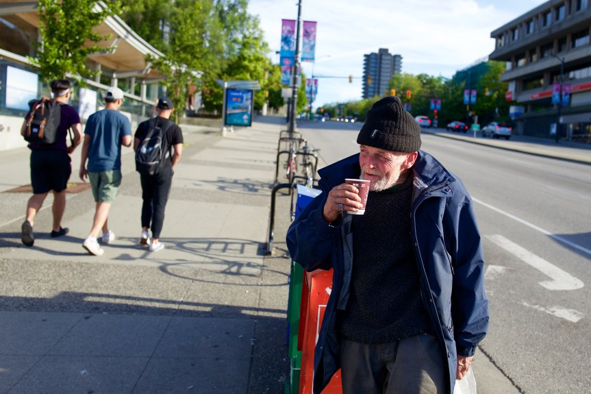 Homeless man enjoying his morning coffee...